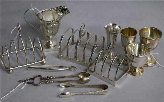 Three silver toast racks, various, a George III style silver helmet cream jug (weighted) and sundry small silver,